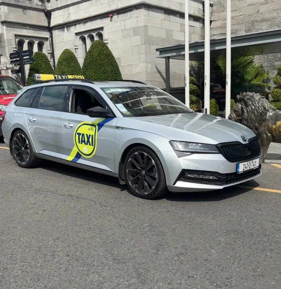 Silver Skoda taxi operated by Drogheda Taxi Biggles on a hotel forecourt